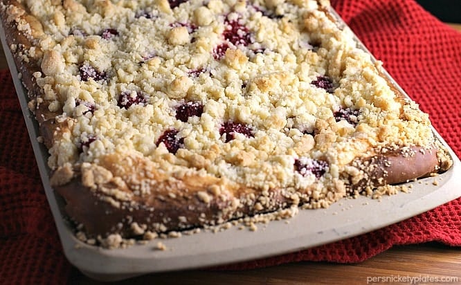 Raspberry Cream Cheese Crumb Cake is layered with a creamy cheesecake , fresh raspberries, and topped with a crunchy streusel topping. Perfect for brunch or dessert! | Persnickety Plates