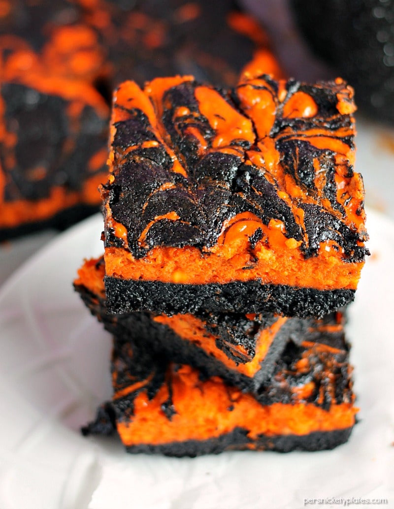 Halloween Cream Cheese Swirl Brownies have a layer of rich, dark chocolate brownie topped with a layer of orange cheesecake then swirled together for a spooky treat. | Persnickety Plates