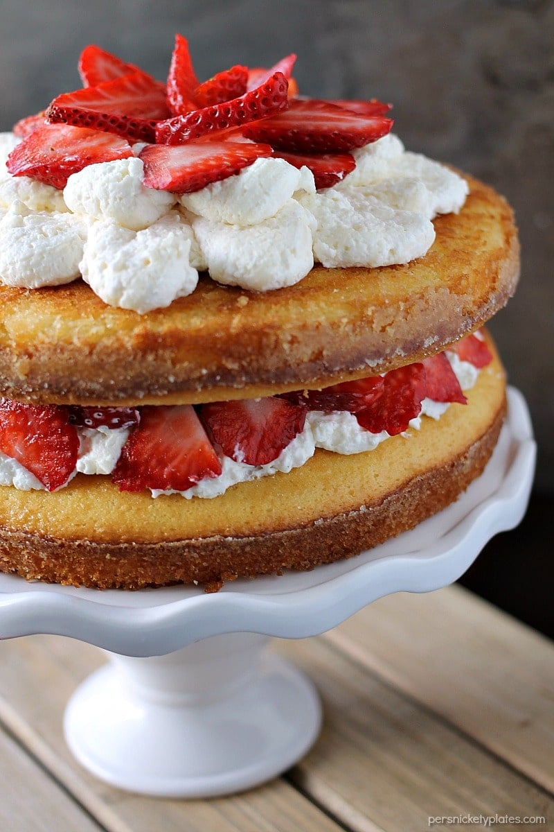 Strawberry Shortcake Cake is a rustic vanilla layer cake filled with a whipped cream cheese frosting and fresh strawberries. Easy, impressive, and SO good! | www.persnicketyplates.com