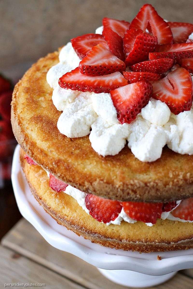 Strawberry Shortcake Cake is a rustic vanilla layer cake filled with a whipped cream cheese frosting and fresh strawberries. Easy, impressive, and SO good! | www.persnicketyplates.com