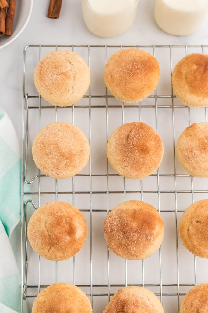 overhead shot of cinnamon and sugar topped muffins on a wire rack.