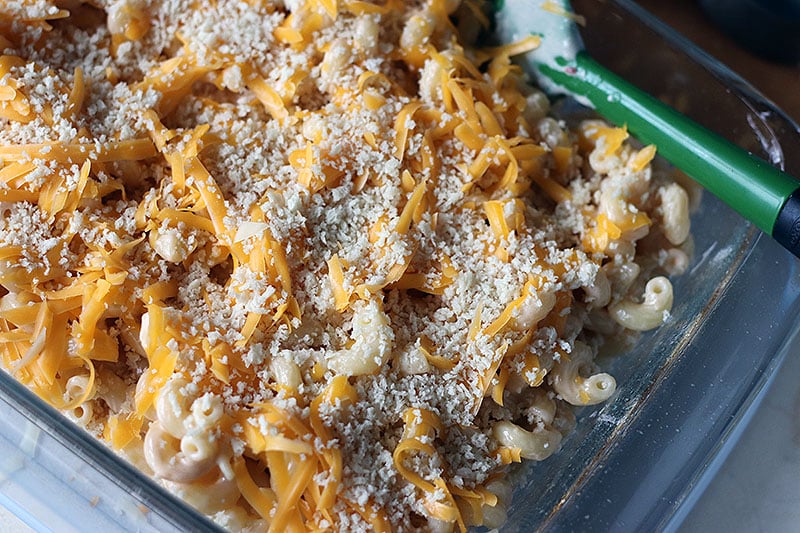 Homemade Baked Macaroni and Cheese is a delicious, super rich, five cheese baked mac and cheese recipe. This copycat steakhouse recipe is fancy enough to serve to guests for holidays, but so delicious, you'll want to make this easy baked mac and cheese recipe every day! www.persnicketyplates.com cheese and panko topping on baked mac and cheese in baking dish