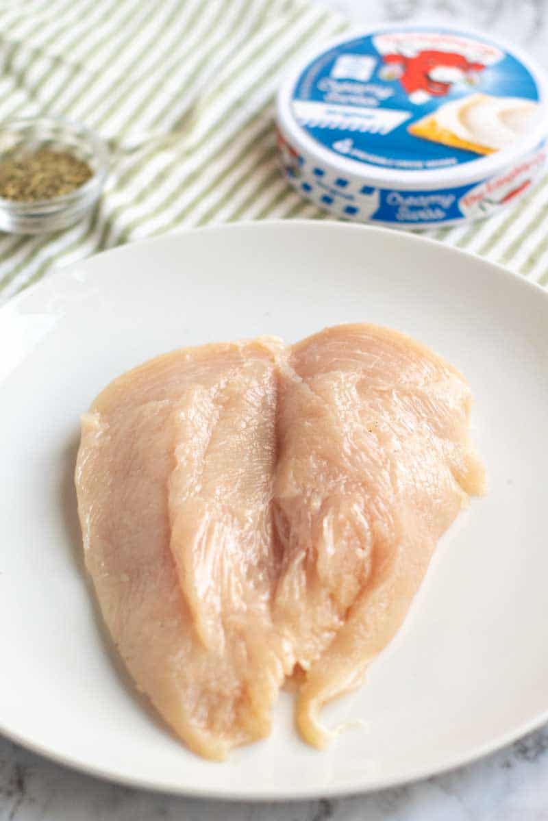 Butterflied chicken breast on a white plate with Laughing Cow cheese in the background Laughing Cow Chicken is a lightened up version of a stuffed chicken breast. This super easy, 5 ingredient dinner will please your picky eaters and wow your foodies. | www.persnicketyplates.com