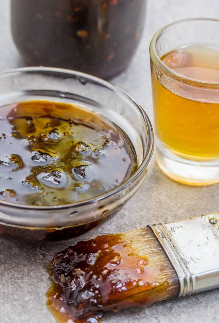 sauce in bowl next to pastry brush of sauce