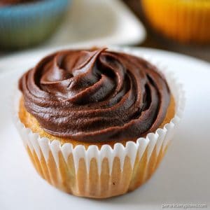 Cheesecake Filled Cupcakes are super simple starting with a cake mix but filled with chocolate chip cheesecake mixture in the centers! | www.persnicketyplates.com