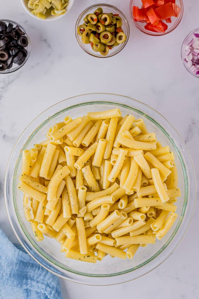 overhead shot of mini ziti noodles in a glass bowl.