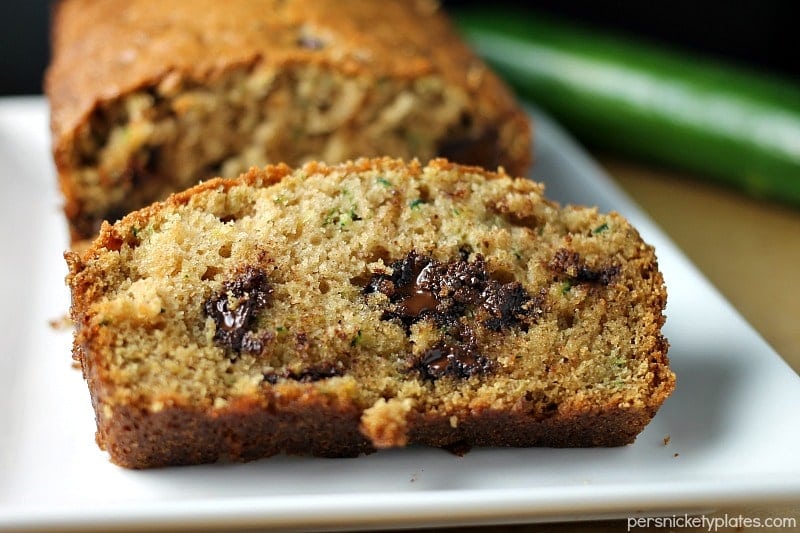 I've been making this Paula Deen Zucchini Bread recipe for years because it really is the best zucchini bread! It's easy to prepare and it makes two loaves so you can share. | www.persnicketyplates.com #zucchinibread #quickbread #dessert #zucchini #chocolatechips close up of sliced zucchini bread with chocolate chips
