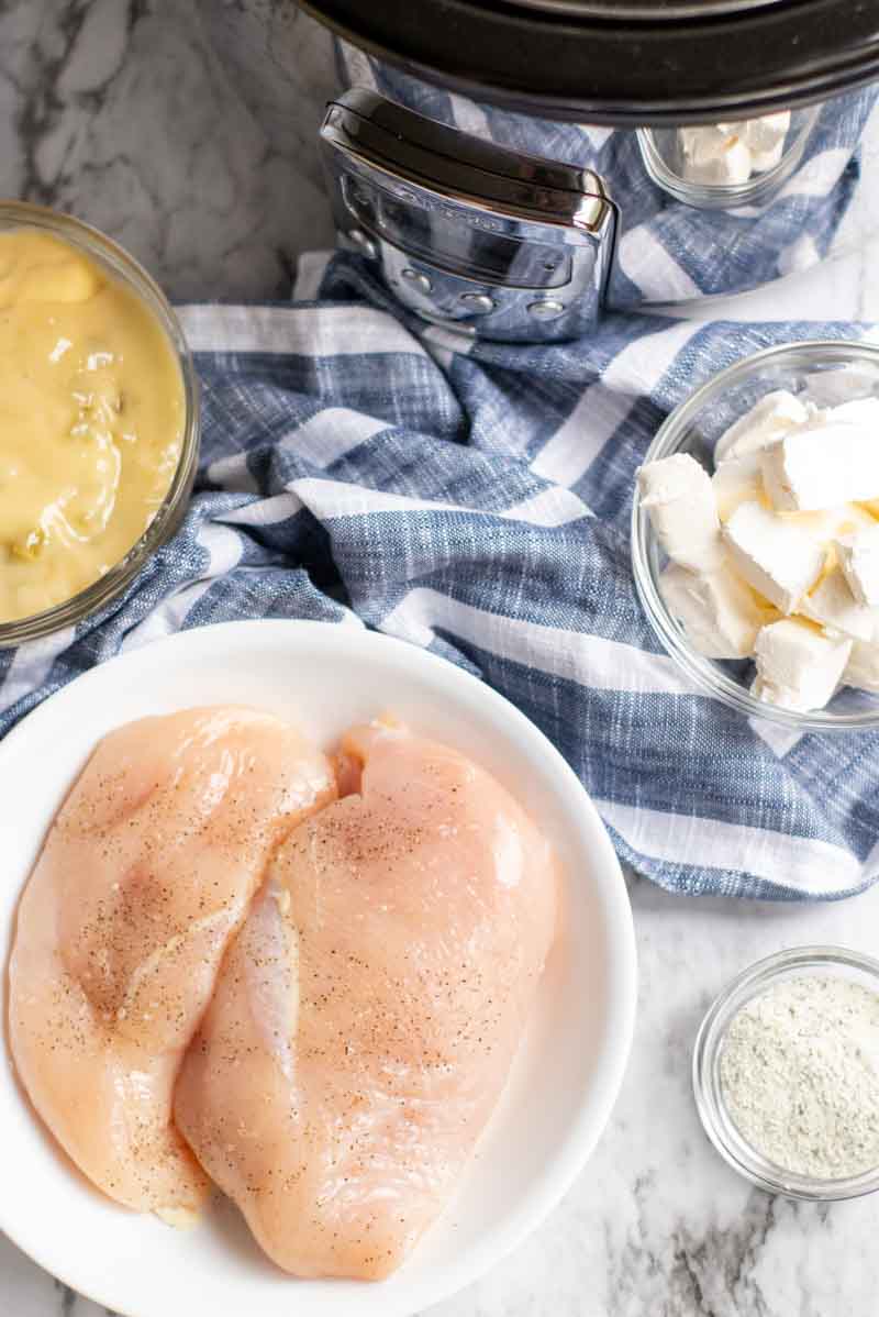 chicken cutlets laid out with a slow cooker