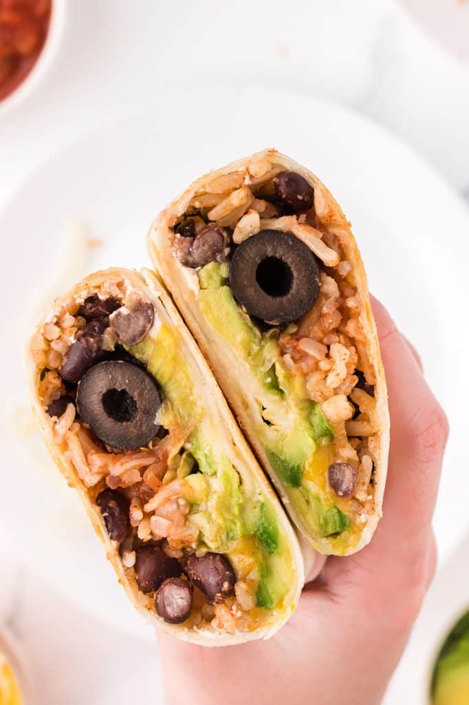 hand holding a black bean wrap.