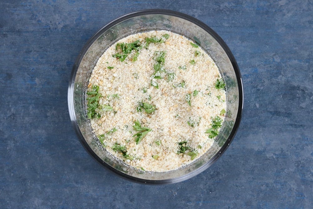Hard Rock Cafe Twisted Macaroni & Cheese is cavatappi pasta tossed in a slightly spicy cheese sauce with roasted red peppers and topped with Parmesan parsley breadcrumbs. A copycat version of a favorite restaurant dish! | www.persnicketyplates.com overhead shot of seasoned bread crumbs
