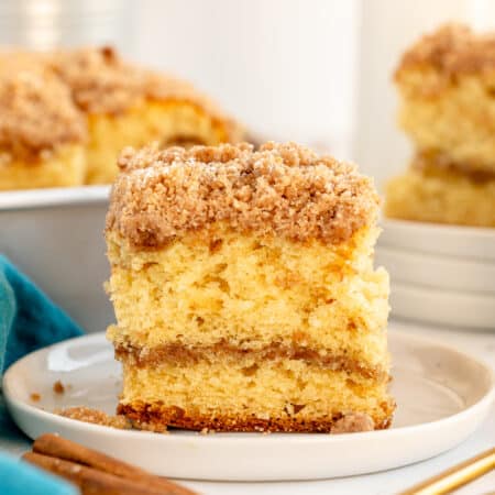 slice of cream cheese coffee cake on a white plate.