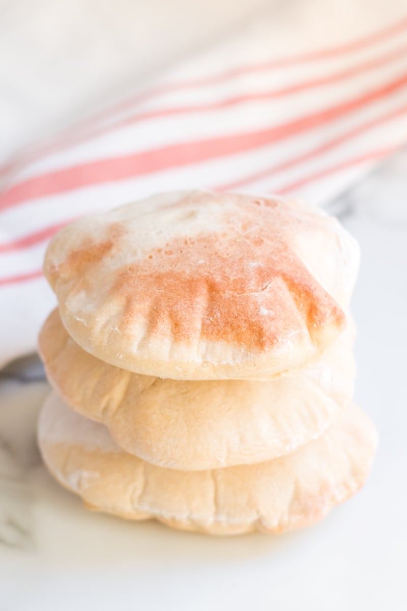 Did you know you can make homemade pita bread with just four ingredients that you likely have in your pantry? You can! And it's really good. | www.persnicketyplates.com stack of 3 golden brown homemade pita breads