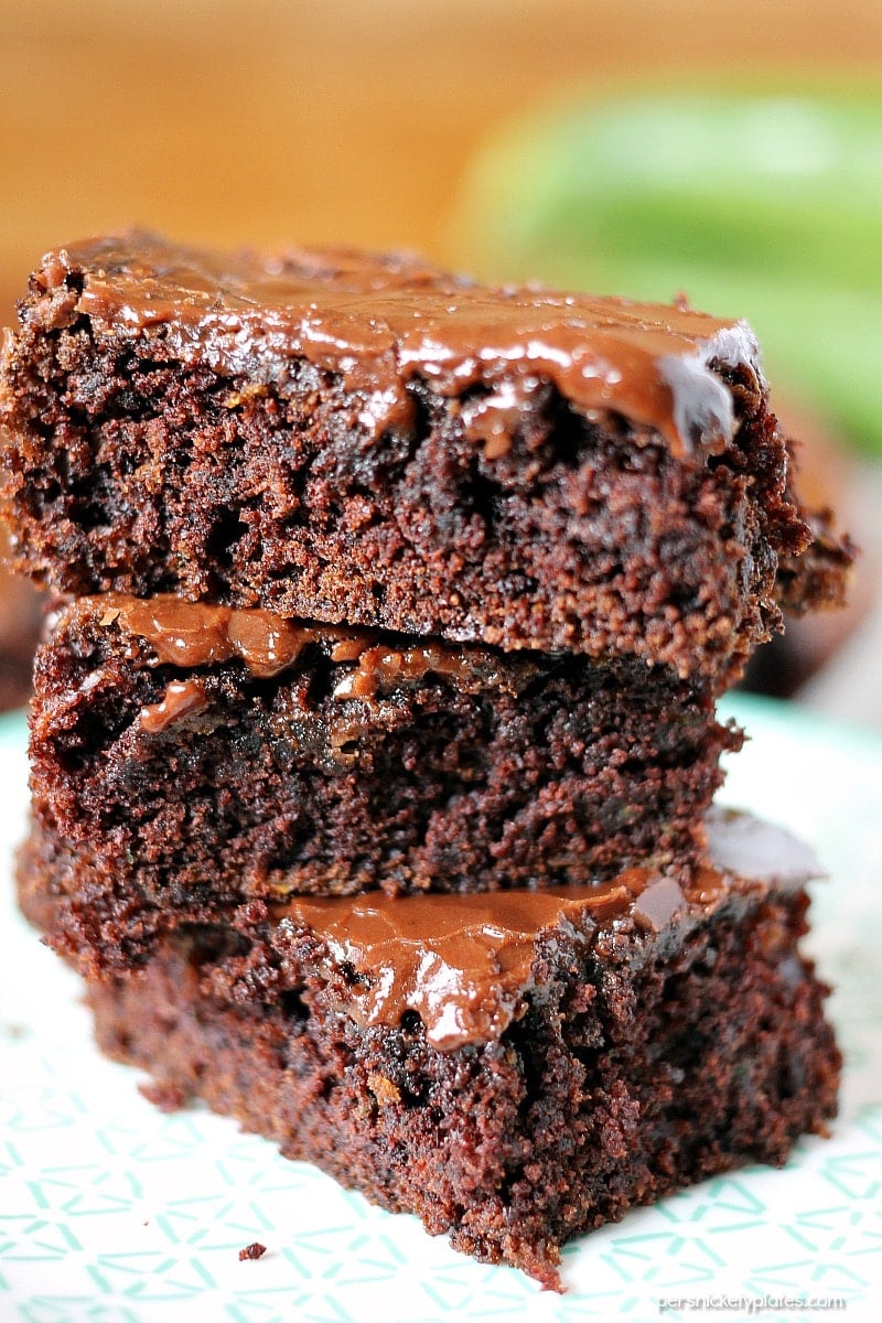 Zucchini Brownies are moist and chocolaty with a simple frosting. They also happen to be dairy-free/vegan. You'll never know there's zucchini hidden in them! | www.persnicketyplates.com