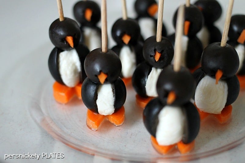 These Olive Penguins are made with black olives, mozzarella balls, and carrots. They are an adorable and fun appetizer, perfect for game day or small gatherings. These delicious poppers are almost too cute to eat!