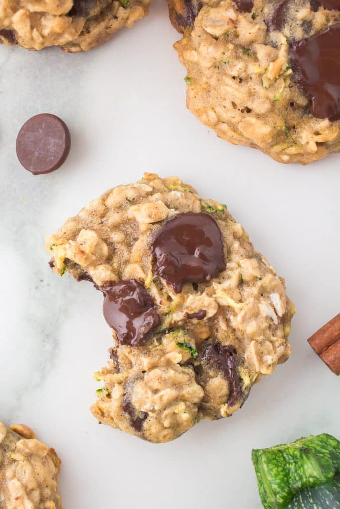 overhead shot of zucchini oatmeal chocolate chip cookie with a bite missing.