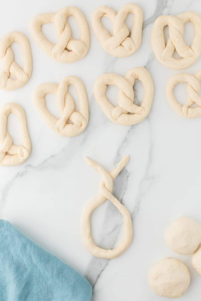 homemade pretzel dough being twisted together.