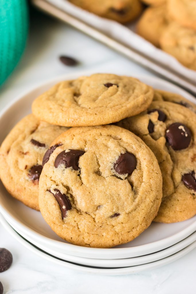 white plate full of chocolate chip cookies made with coconut oil.