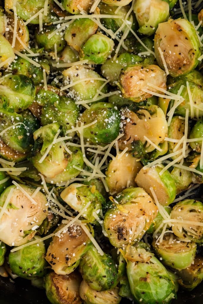 closeup of brussels sprouts sprinkled with parmesan cheese.