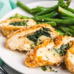 Cajun stuffed chicken breasts sliced open with gooey melted cheese and spinach inside.