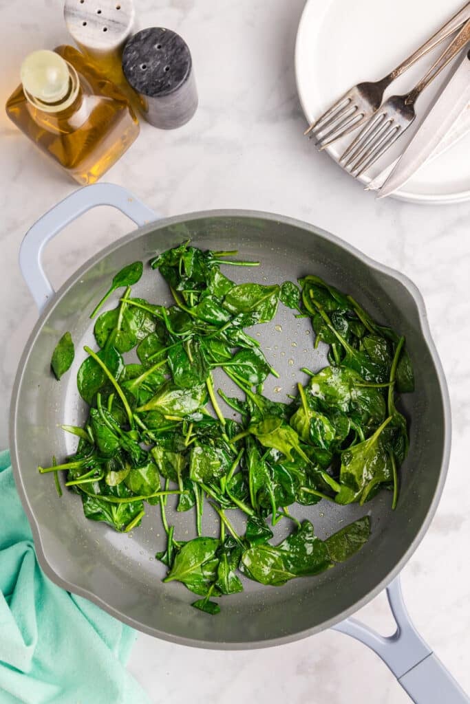 wilted spinach in a skillet.