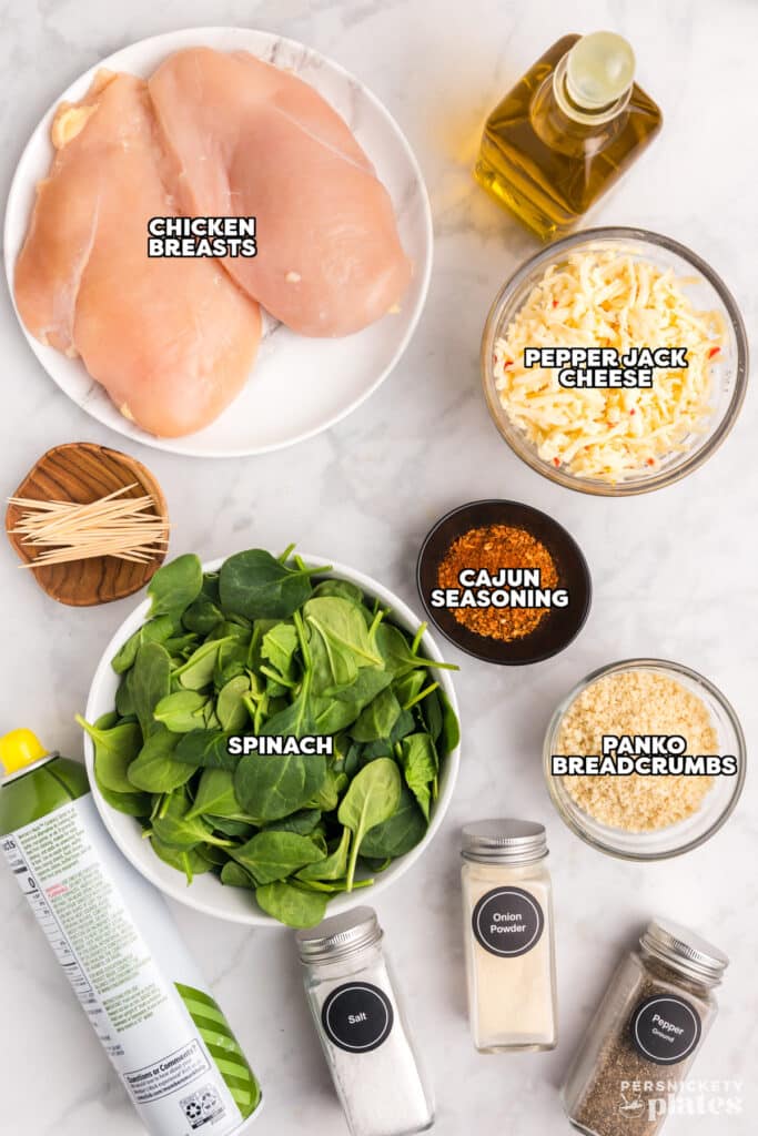 overhead shot of labeled ingredients laid out to make stuffed chicken breasts.