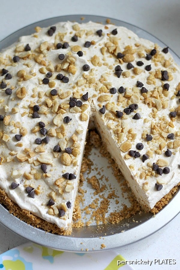 overhead shot of frozen peanut butter pie missing one slice overhead shot of a peanut butter pie with one slice missing.
