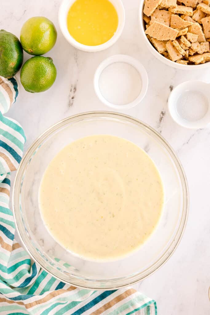 key lime pie filling being mixed in a mixing bowl.