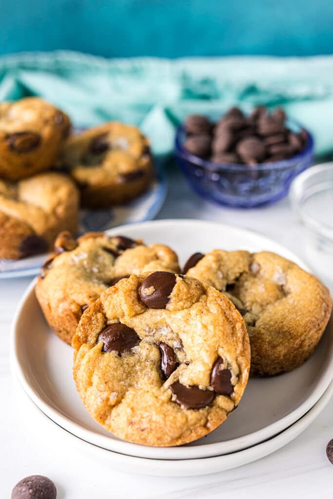 three chocolate chip cookie cups on a plate.