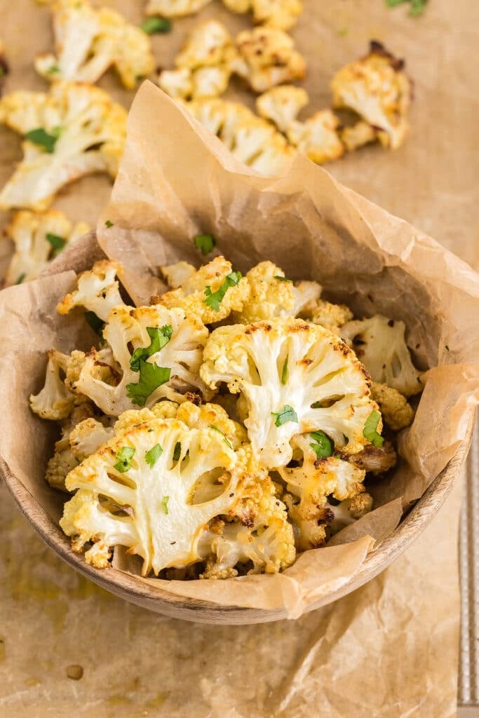 bowl of roasted cauliflower garnished with parsley.