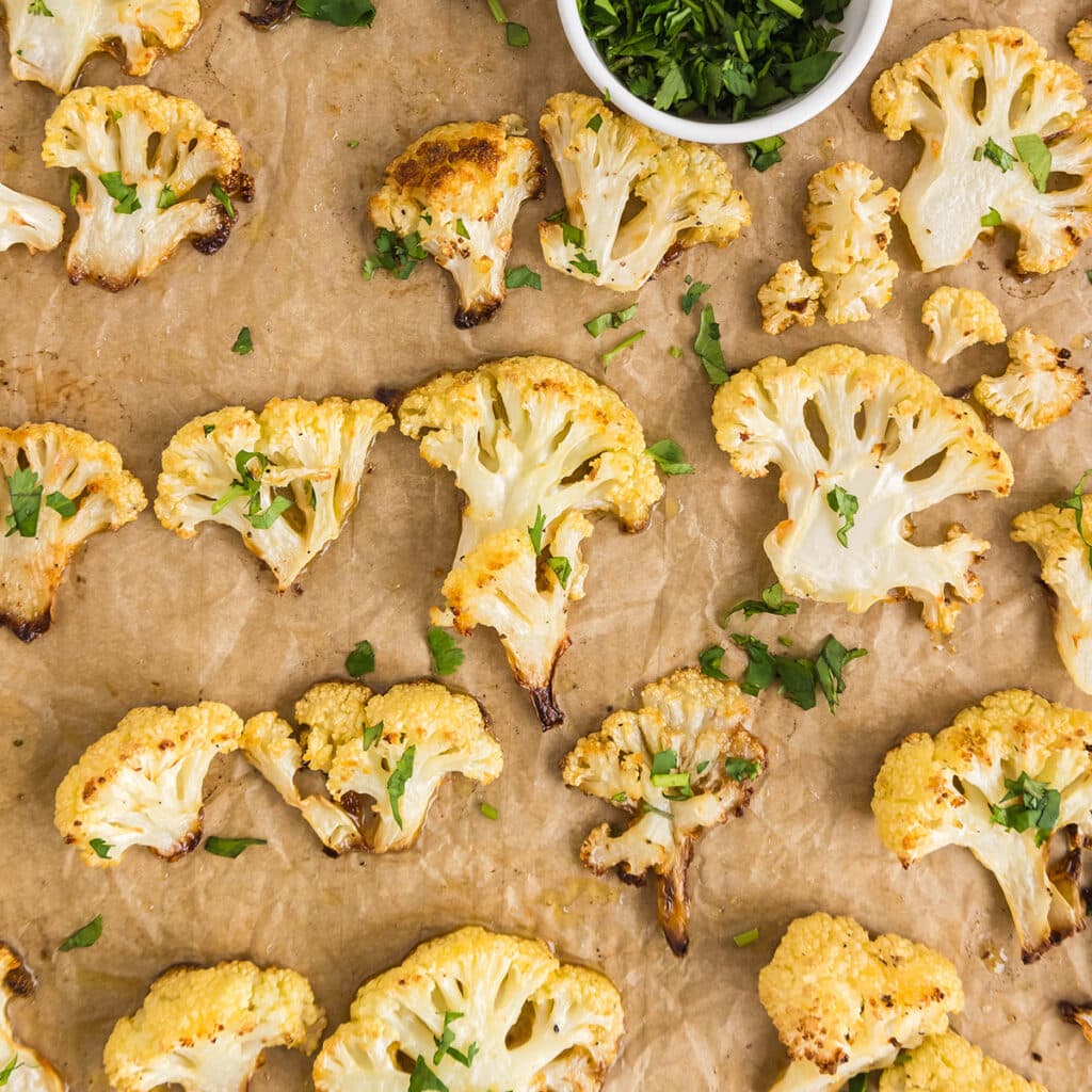 overhead shot of roasted cauliflower on a baking sheet.