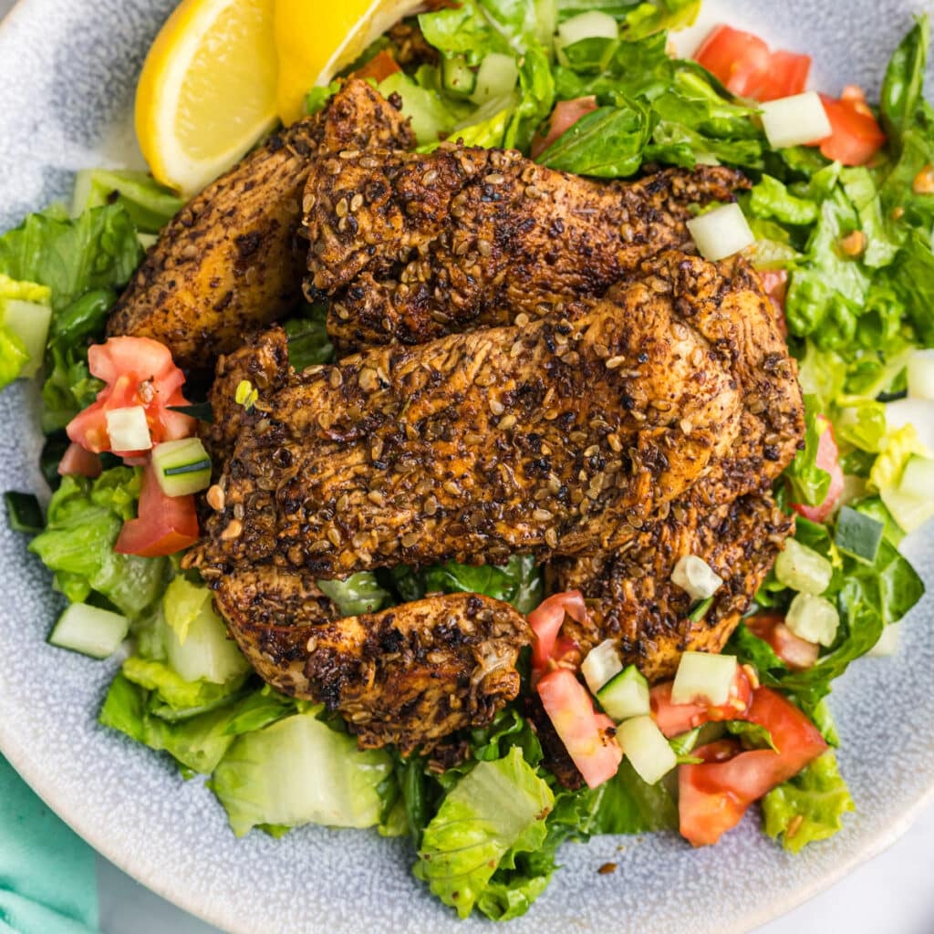 overhead shot of salad topped with za'atar chicken.