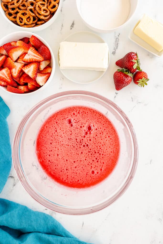 strawberry gelatin in a glass mixing bowl.