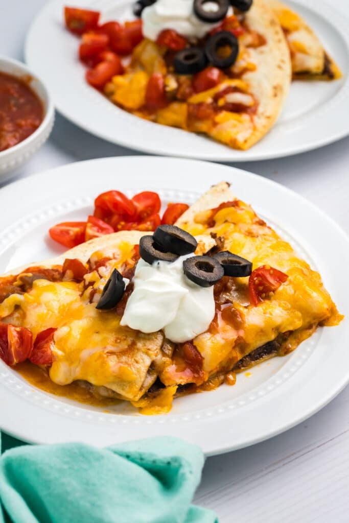 mexican pizza topped with sour cream and black olives.