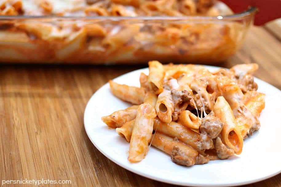 Baked Mostaccioli is a super simple and tasty pasta with a blend of marinara and alfredo sauces. With only five ingredients, it comes together fast and is perfect for an easy dinner! | www.persnicketyplates.com baked mostaccioli serving on a white plate