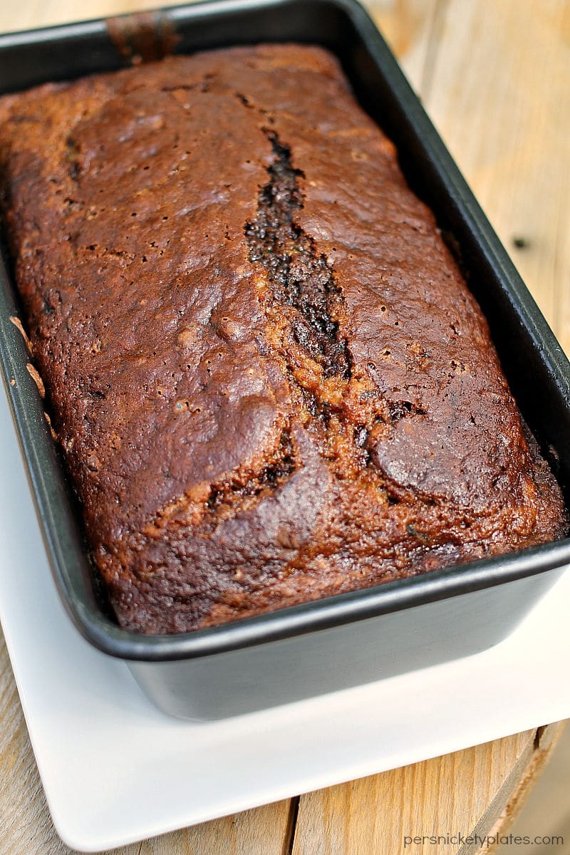 Chocolate Marble Zucchini Bread - give classic zucchini bread an upgrade when you swirl in chocolate batter and mini chocolate chips! | www.persnicketyplates.com chocolate marble zucchini bread in a loaf pan