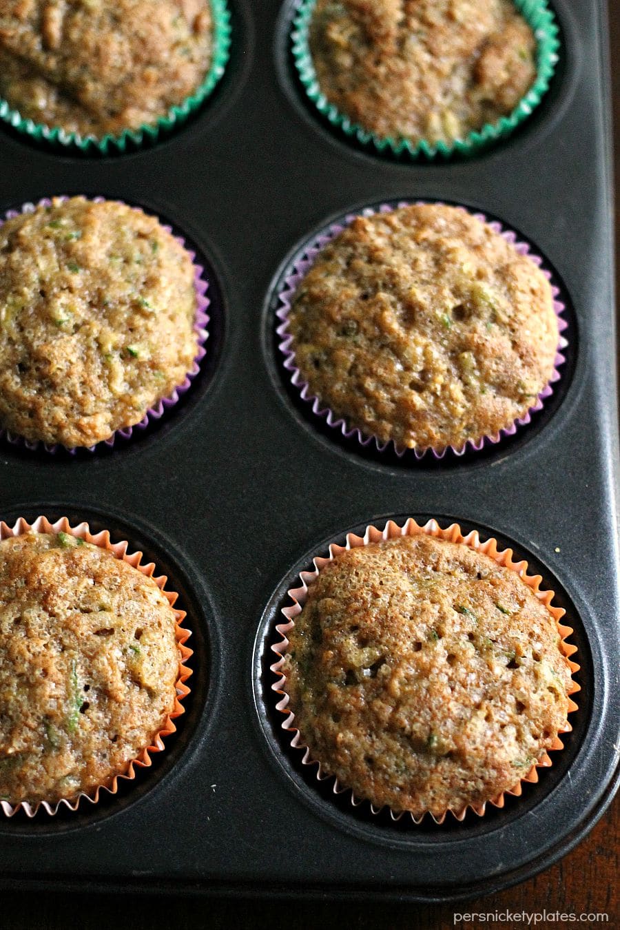 overhead shot of apple zucchini muffins in muffin tray overhead shot of pan of apple zucchini muffins.