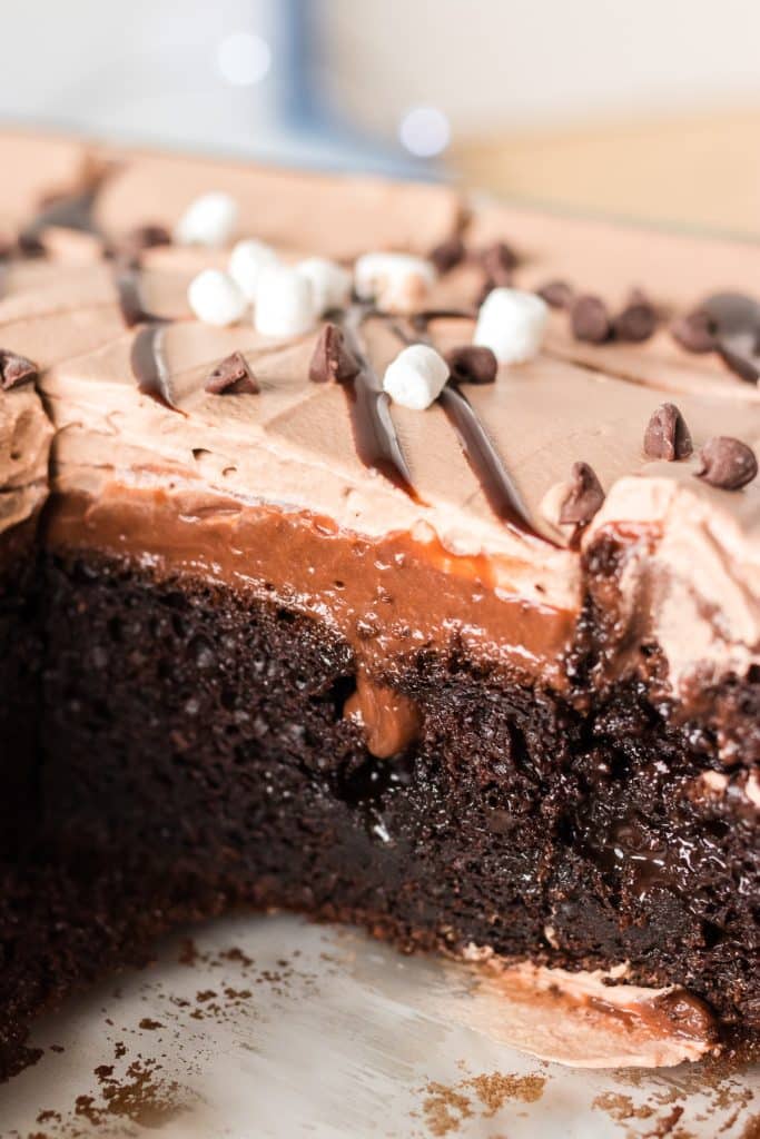 side view of a hot chocolate poke cake with chocolate layers.