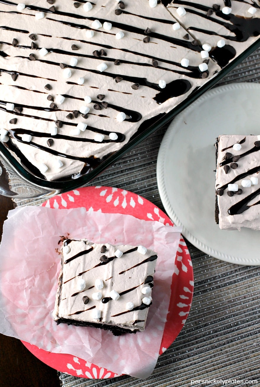 This Hot Chocolate Poke Cake takes everything you love about hot chocolate and puts it into cake form. Perfect for a holiday celebration! | Persnickety Plates