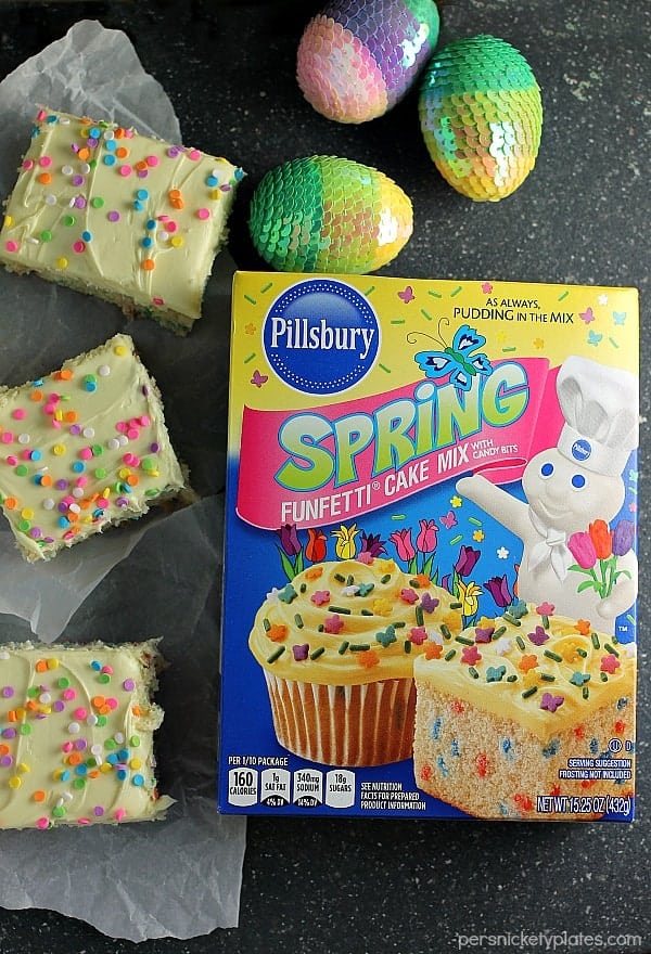 box of spring funfetti cake mix surrounded by cream cheese funfetti bars Cream Cheese Funfetti Bars are simple, semi-homemade treats that are perfect to kick off spring baking. Start with a box funfetti cake mix and add cream cheese to make these fun and delicious bars! | www.persnicketyplates.com
