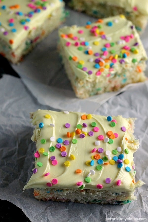 overhead shot of four cream cheese funfetti bars topped with sprinkles Cream Cheese Funfetti Bars are simple, semi-homemade treats that are perfect to kick off spring baking. Start with a box funfetti cake mix and add cream cheese to make these fun and delicious bars! | www.persnicketyplates.com