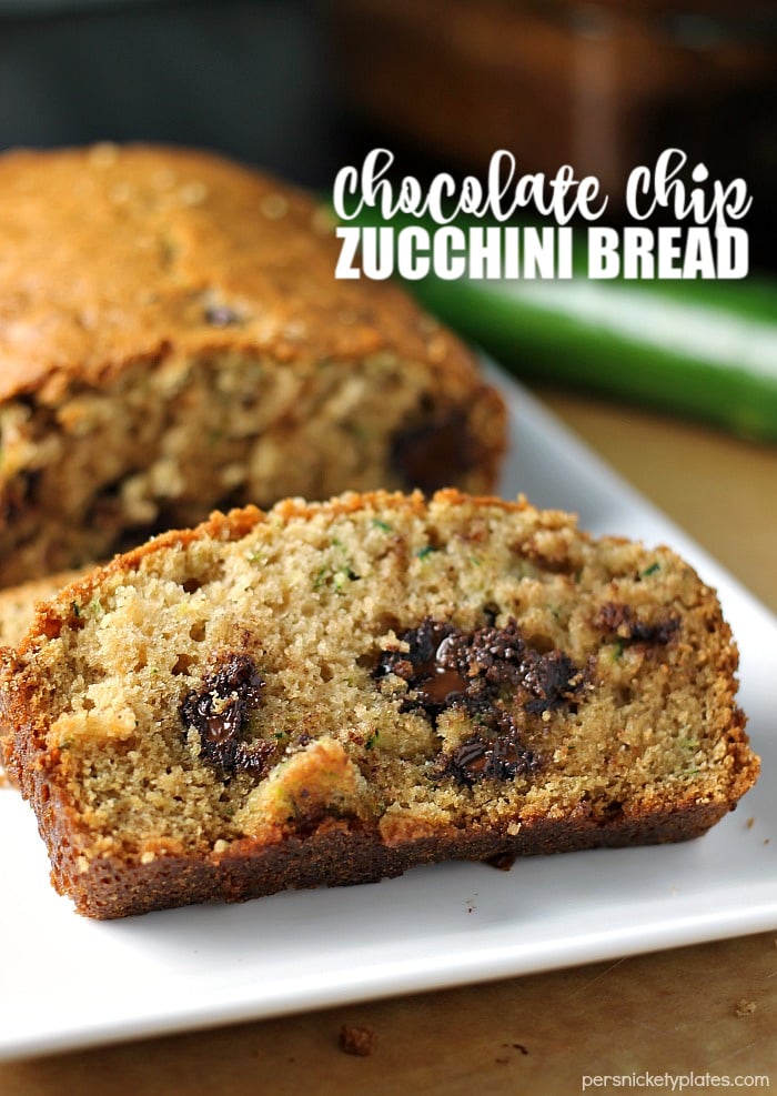 I've been making this Paula Deen Zucchini Bread recipe for years because it really is the best zucchini bread! It's easy to prepare and it makes two loaves so you can share. | www.persnicketyplates.com #zucchinibread #quickbread #dessert #zucchini #chocolatechips sliced chocolate chip zucchini bread on white plate