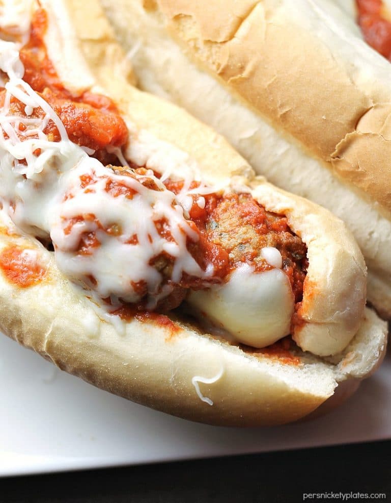 Easy Italian Chicken Meatball Subs smothered in a homemade marinara sauce and topped with provolone and mozzarella cheese! | Persnickety Plates