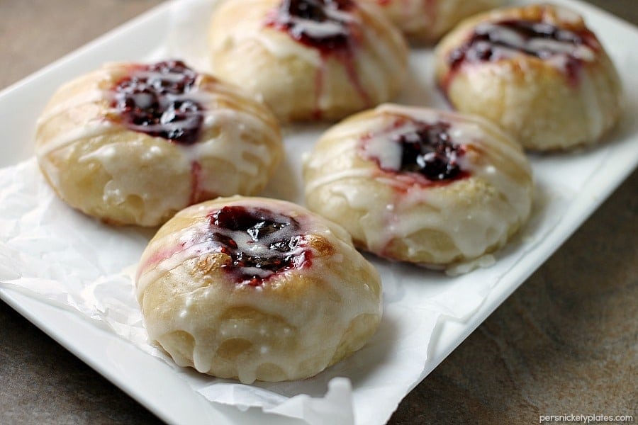 white platter with raspberry thumbprint donuts on it