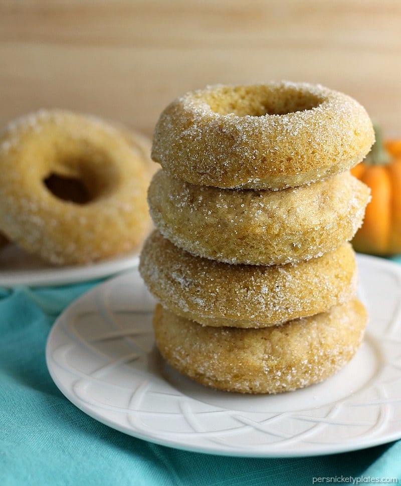 stack of 4 donuts on a white plate