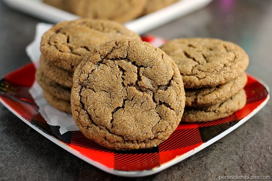 close up of ginger snap cookie with stack of cookies in background