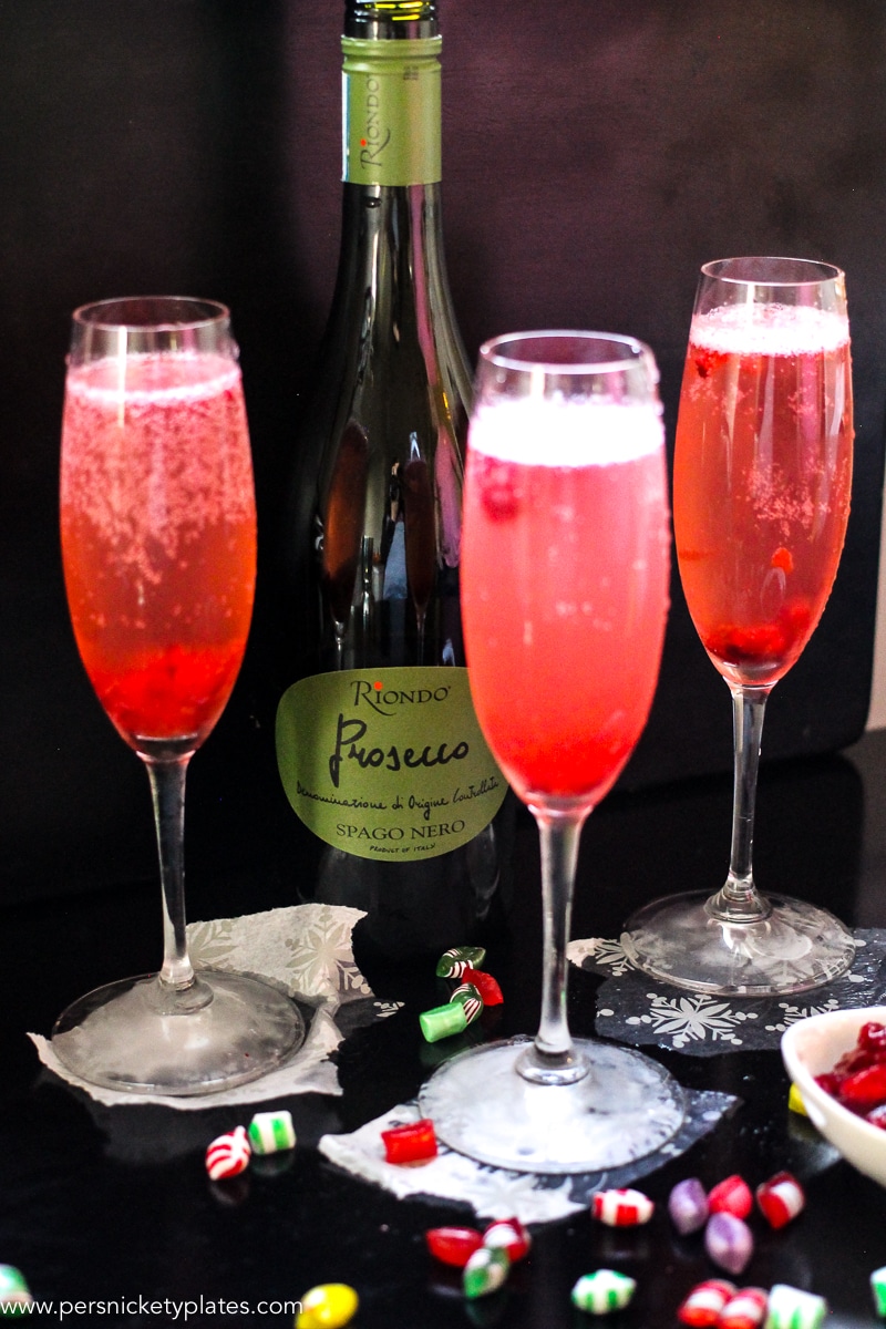 This Cranberry Prosecco Spritzer combines the vibrant bubbles of Riondo Prosecco with the warm winter notes of spearmint and cranberries. It's the perfect accompaniment to wrapping gifts and spending time with family and friends around the fire or in the kitchen. | www.persnicketyplates.com