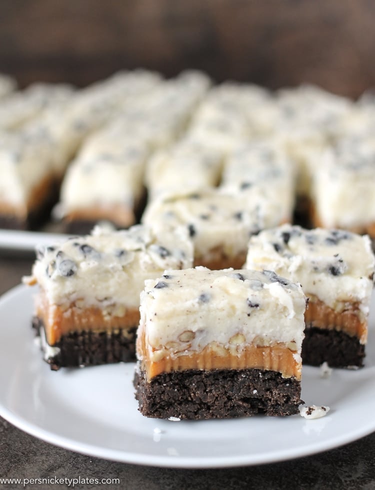 three cookies and cream caramel layer bars on a plate