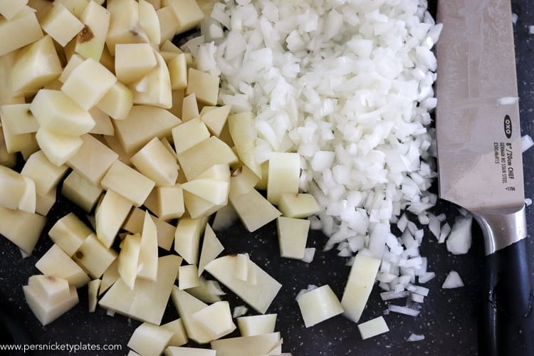 chopped potatoes and onions with an oxo pro chef's knife