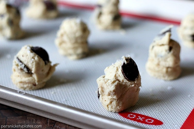 Once you try these thick, chewy, cake-like Salted Chocolate Chip Cookies, you're going to forget about all your other chocolate chip cookie recipes! | www.persnicketyplates.com cookie sheet of Salted Chocolate Chip Cookies ready to go into oven