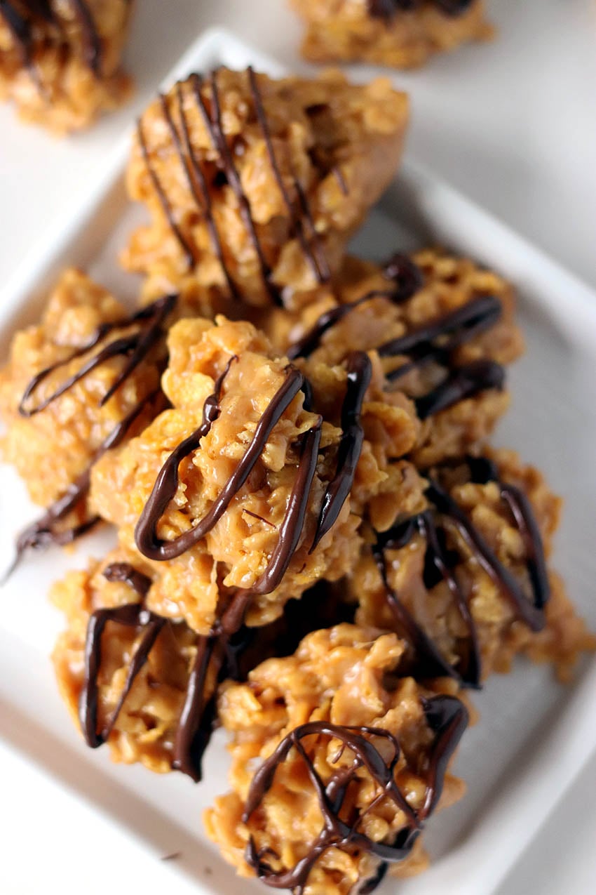 platter of cornflake cookies drizzled with chocolate.
